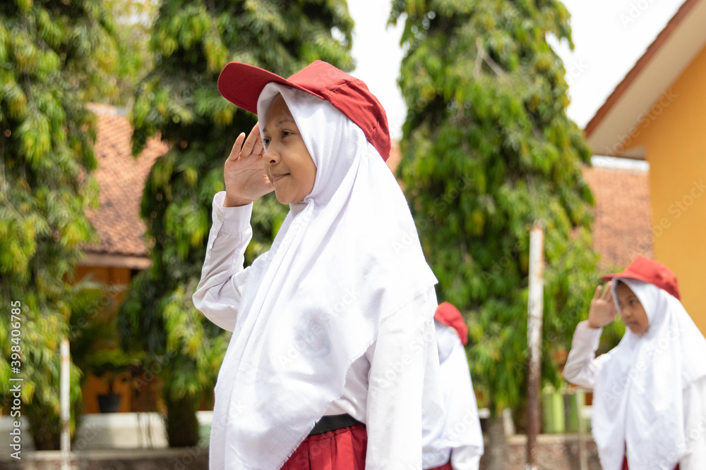 honor is performed by student little girl ceremonial flag raising in indonesia