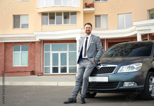 Successful businessman near modern car © Pixel-Shot
