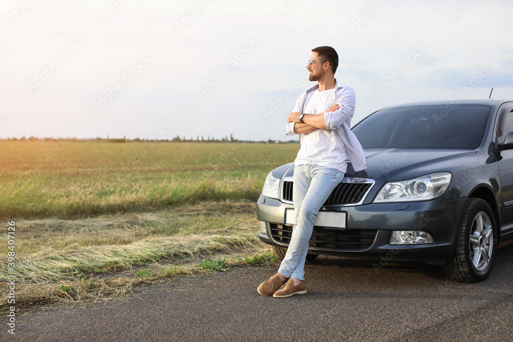 Handsome man near modern car outdoors Handsome man near modern car outdoors