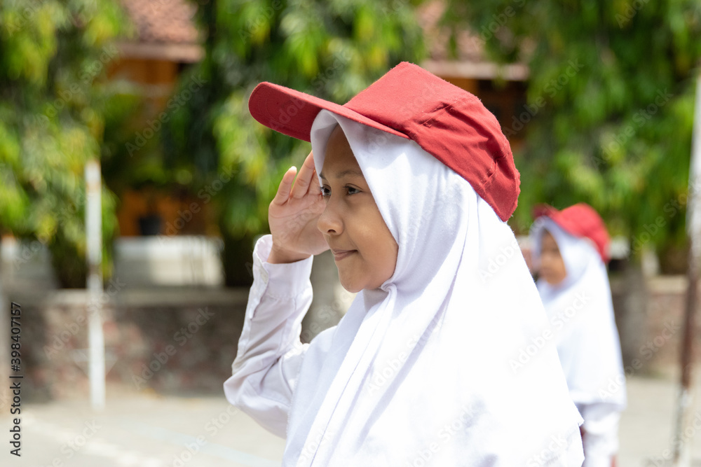 honor is performed by student little girl ceremonial flag raising in indonesia