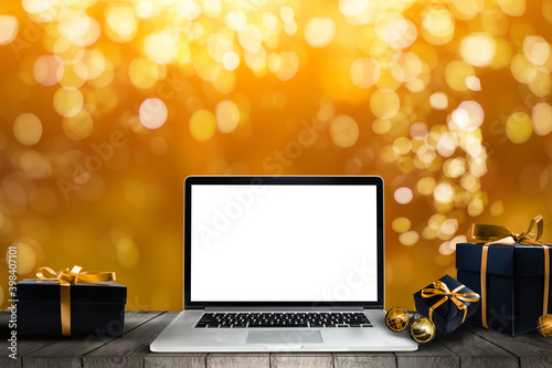 laptop with gift box and christmas lights background