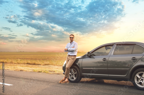 Handsome man near modern car © Pixel-Shot