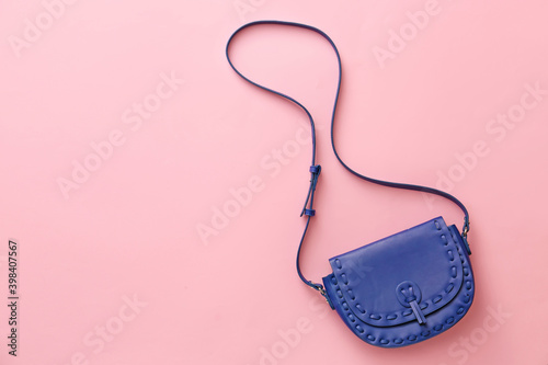 Stylish bag on color background