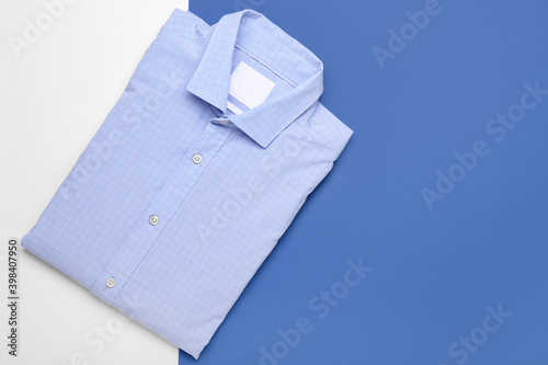 New male shirts on color background