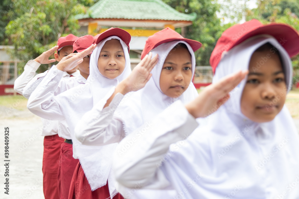 Flag honor is performed by the Indonesian elementary students in their school Flag honor is performed by the Indonesian elementary students in their school