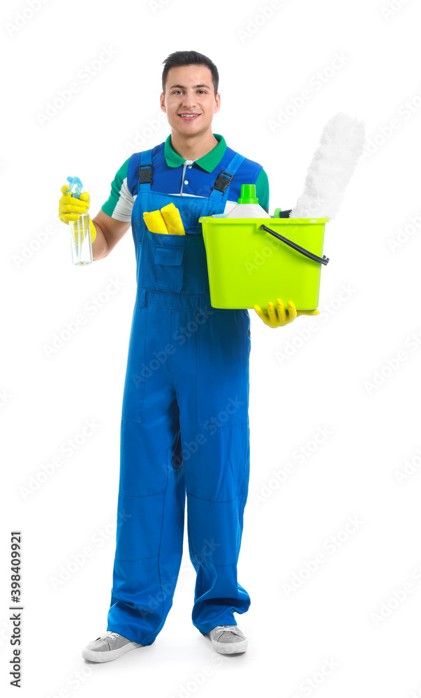 Young male janitor with cleaning supplies on white background Young male janitor with cleaning supplies on white background
