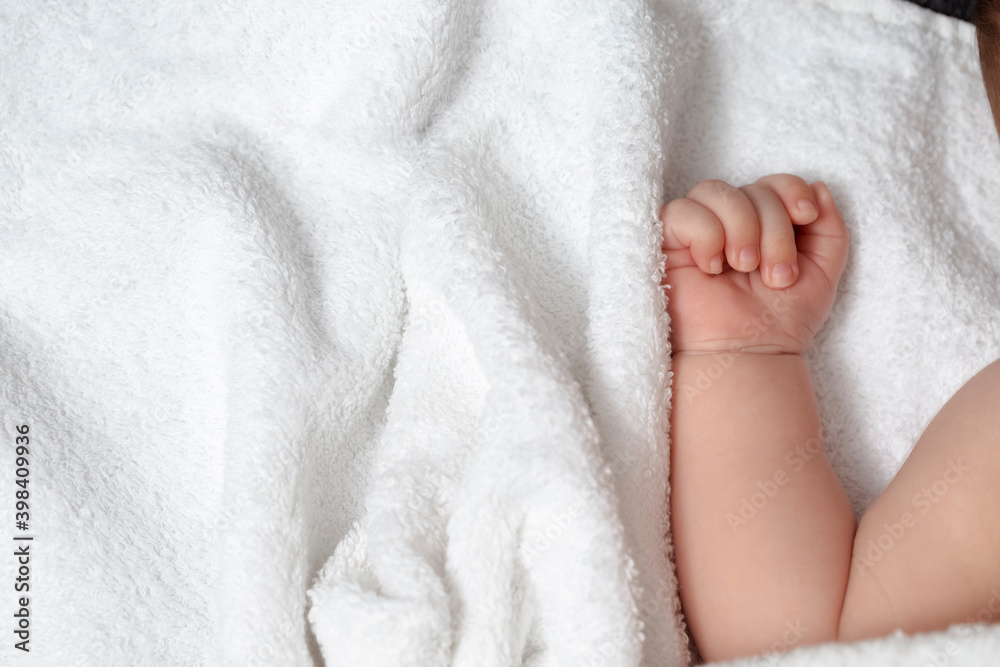 Close-up Shoot of a Four Week Old Baby Boy Arm and Tiny Fingers Against White Blanket. Close-up Shoot of a Four Week Old Baby Boy Arm and Tiny Fingers Against White Blanket.