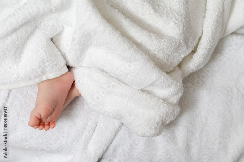 Newborn Ideas. Top Close-up View of a Four Week Old Baby Boy Feet Over Heap of White Towes. © danmorgan12