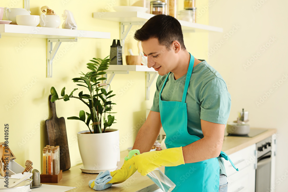 Young man cleaning his kitchen Young man cleaning his kitchen