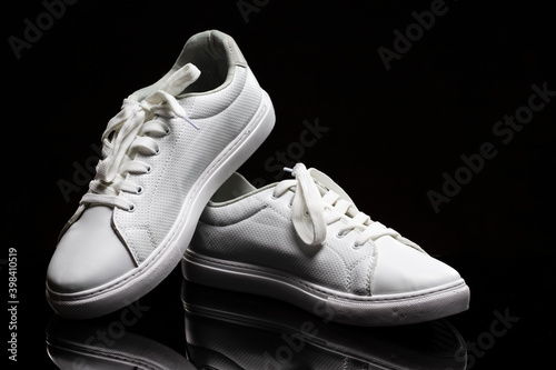 Sports Footwar Concepts. Pair of White New Sneakers Shoes On Black Background.