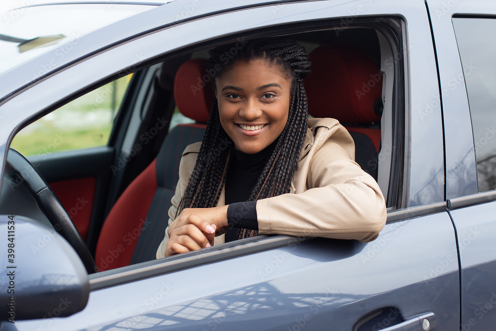 Happy girl in a car driving, African American