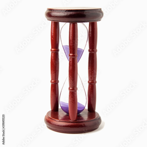 Wooden vintage hourglass isolated on white background photo