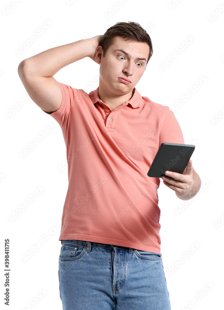 Shocked young man with e-reader on white background