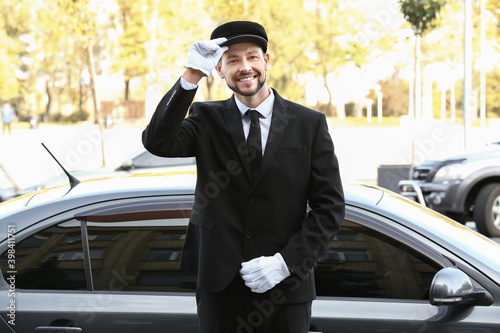 Fotografie Portrait of handsome chauffeur near luxury car