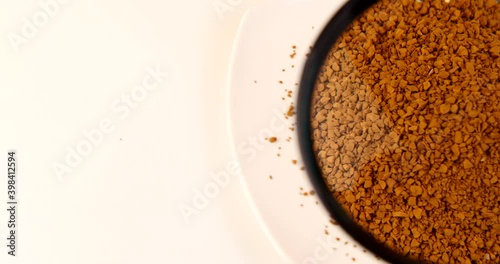 loose coffee granules on a white dish close-up 4k video