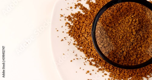 loose coffee granules on a white dish close-up 4k video