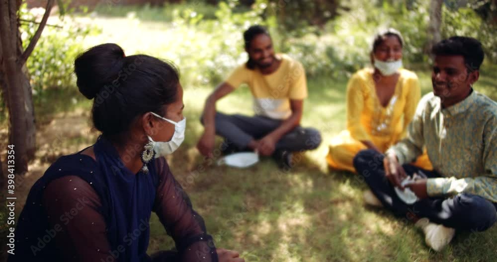 Slow-motion static medium-shot MS of one female friend in the nature park garden as she argues with her friends to wear mask cover their mouth to protect but to no avail Slow-motion static medium-shot MS of one female friend in the nature park garden as she argues with her friends to wear mask cover their mouth to protect but to no avail