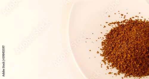 loose coffee granules on a white dish close-up 4k video
