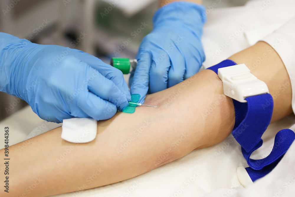taking blood from a vein closeup. blood test in the hospital. the