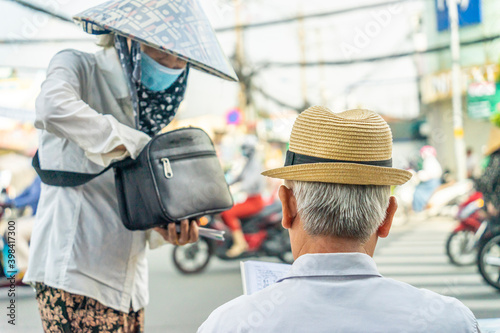 a scene of a woman in a conical hat selling a lottery ticket to an elderly man in Vietnam
