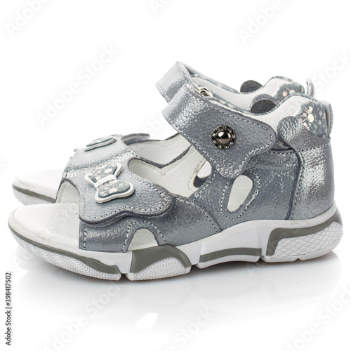 Pair of silver sandals for little girls on a white background.