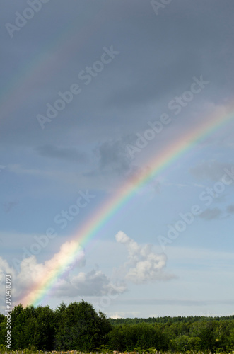Colorful rainbow over cloudy sky