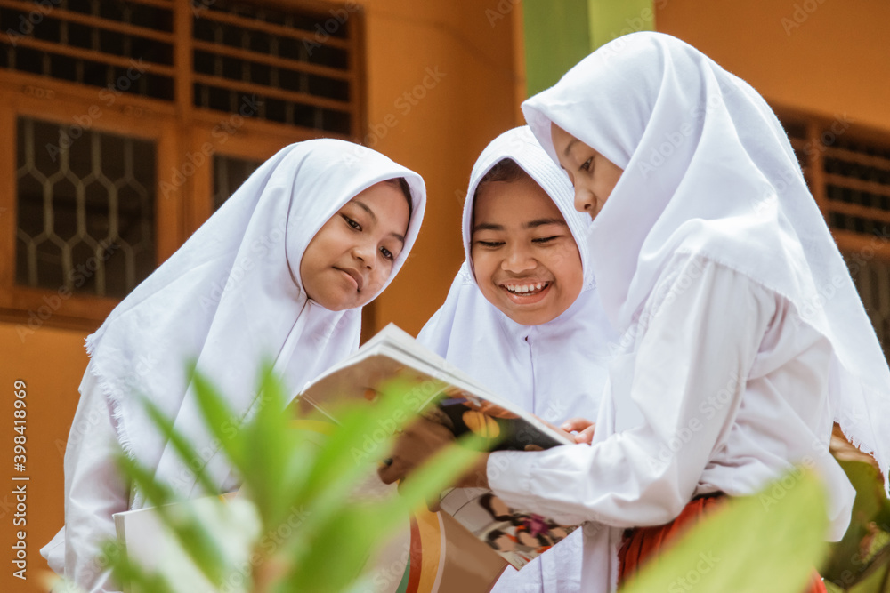 islamic school students studying together in the school garden Stock