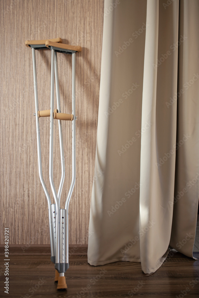 Crutches stand against a wall in a room Crutches stand against a wall in a room