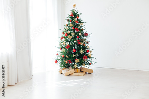 Christmas tree with new year gifts in the white room photo