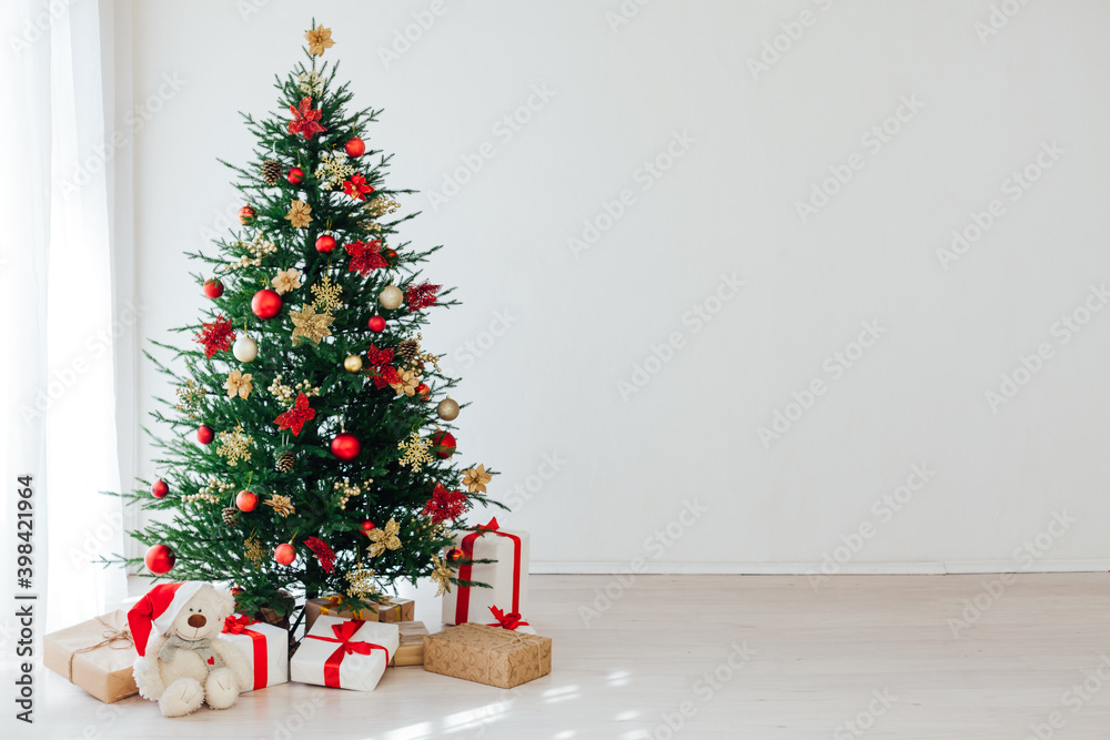 Christmas tree with new year gifts in the white room Christmas tree with new year gifts in the white room