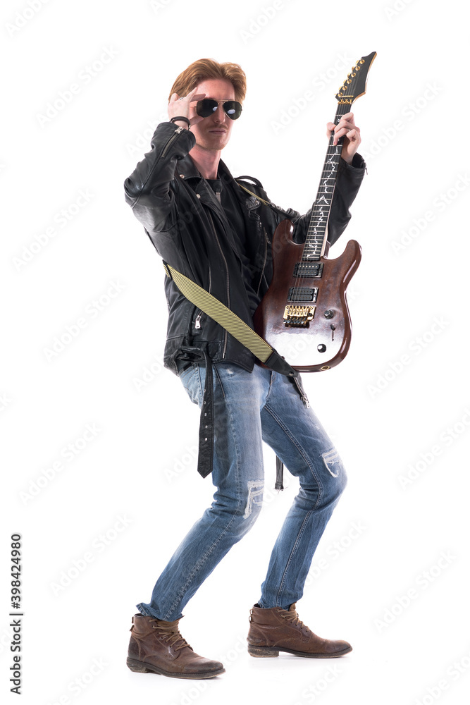 Cool macho stylish redhead rocker posing with his electric guitar. Side view. Full body length isolated on white background. Cool macho stylish redhead rocker posing with his electric guitar. Side view. Full body length isolated on white background.