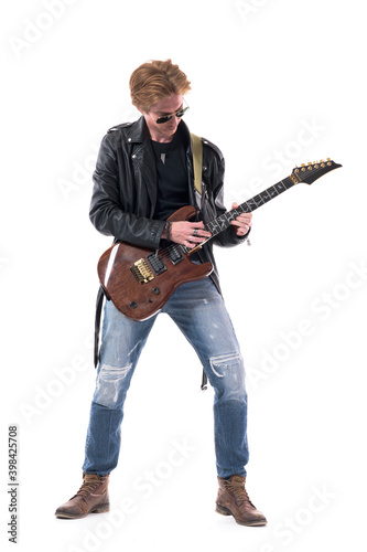 Talented young stylish redhead rocker practicing rehearsal on electric guitar. Full body length isolated on white background.  © sharplaninac