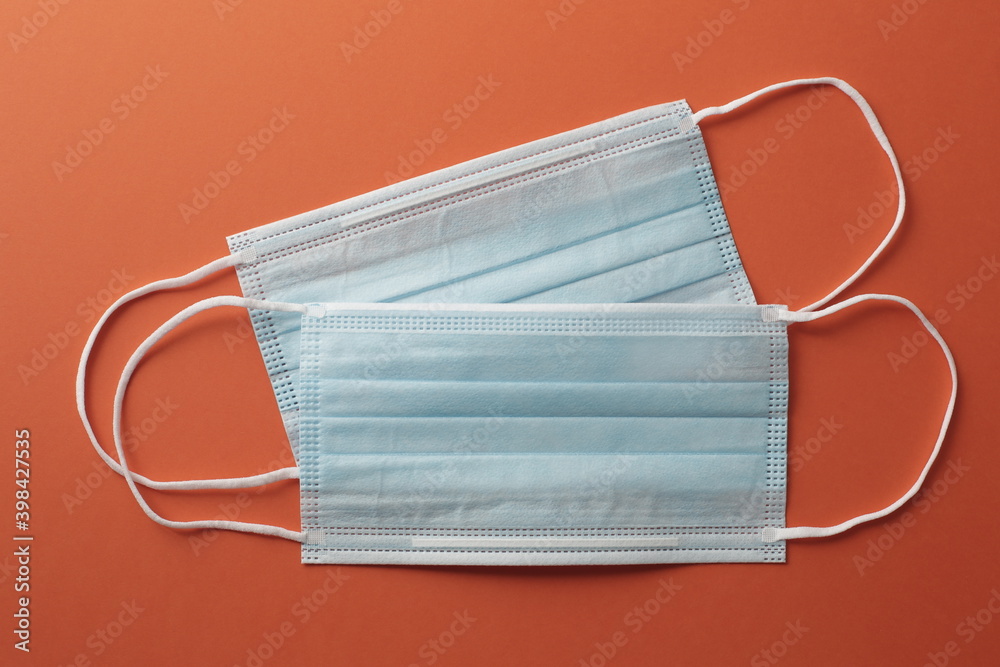 Respiratory masks on orange background. Protective medical mask. Coronavirus protection concept.