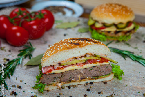 Fresh and juicy hamburger. Delicious cheese burger on a rustic wooden table