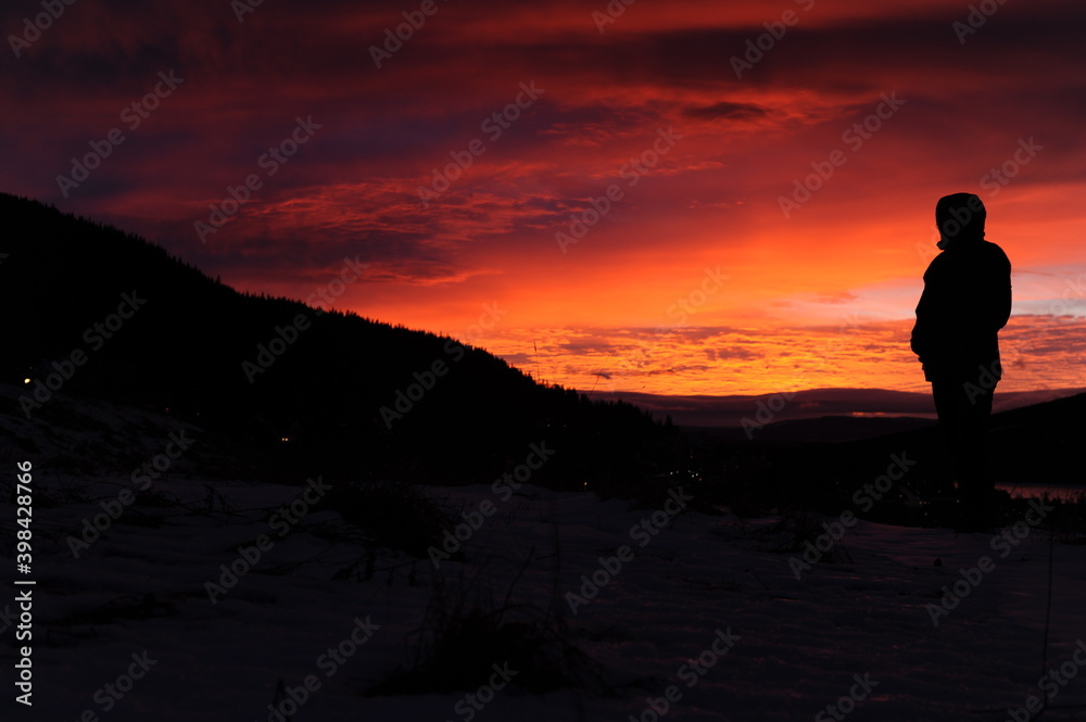 Black silhouette on mountain plateau during sunset with colorful red, violet, orange sky and clouds in winter in Scandinavia Black silhouette on mountain plateau during sunset with colorful red, violet, orange sky and clouds in winter in Scandinavia