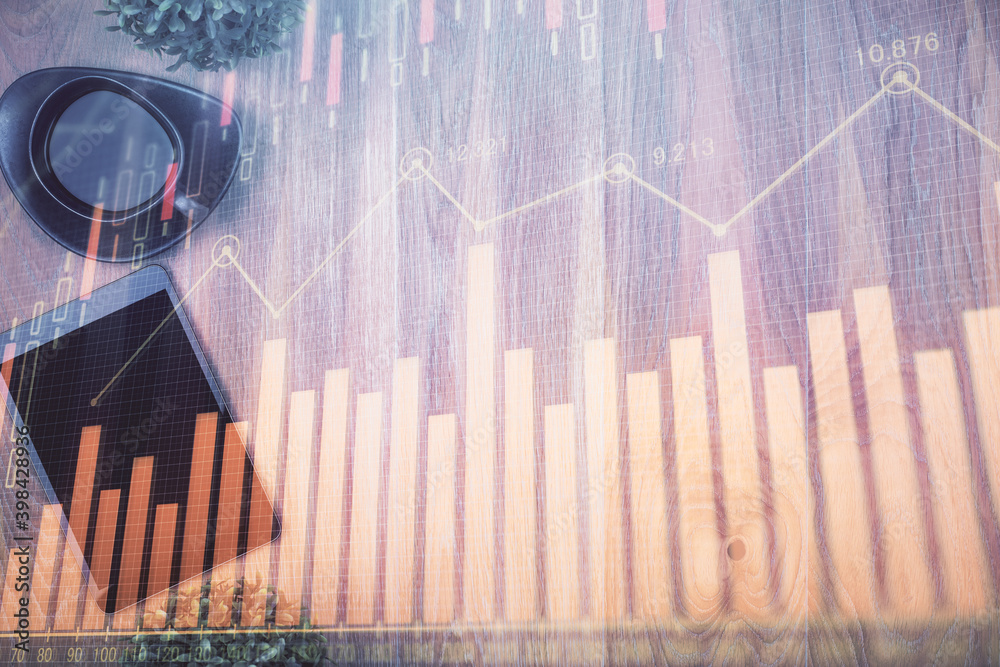 Multi exposure of financial chart hologram over desktop with phone. Top view. Mobile trade platform concept. Multi exposure of financial chart hologram over desktop with phone. Top view. Mobile trade platform concept.