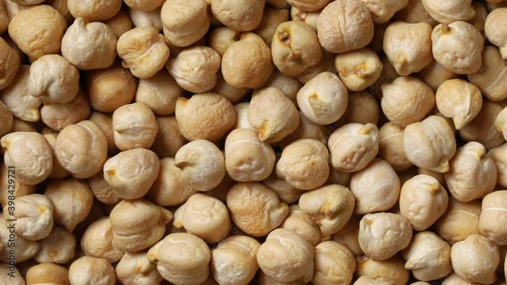 Dried raw whole chickpeas full frame close up as a background