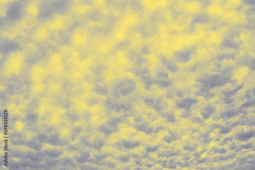 Cloudy sky background in Illuminating yellow and Ultimate Gray color of the year 2021. Soft texture. Cloudy sky background in Illuminating yellow and Ultimate Gray color of the year 2021. Soft texture.