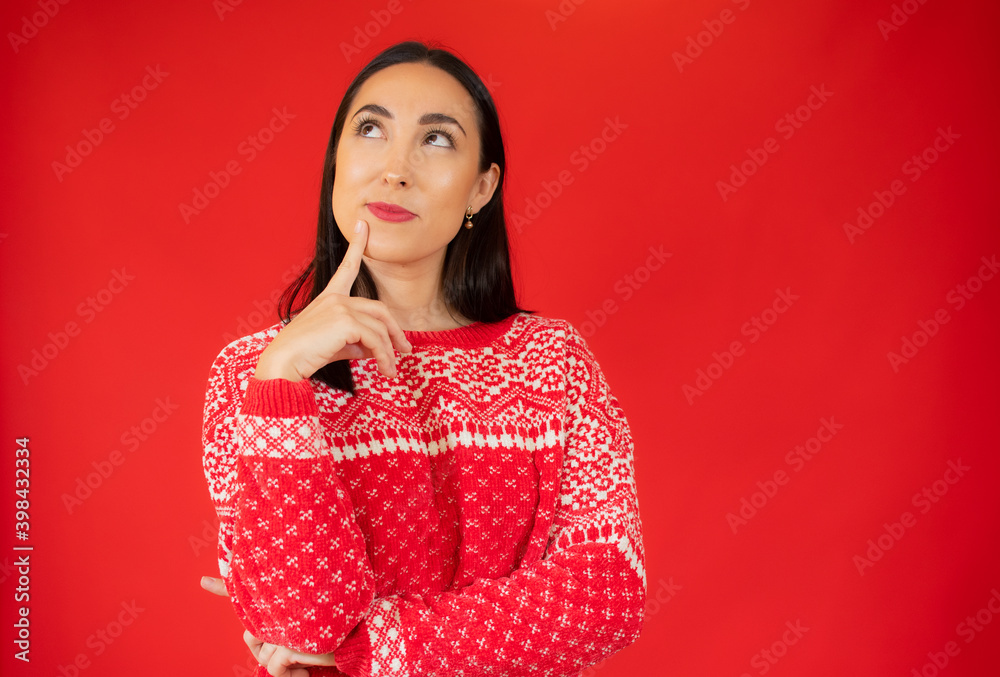 Young beautiful woman wearing casual sweater over red isolated background confuse and wondering about question. Uncertain with doubt, thinking with hand on face. Pensive concept. Young beautiful woman wearing casual sweater over red isolated background confuse and wondering about question. Uncertain with doubt, thinking with hand on face. Pensive concept.