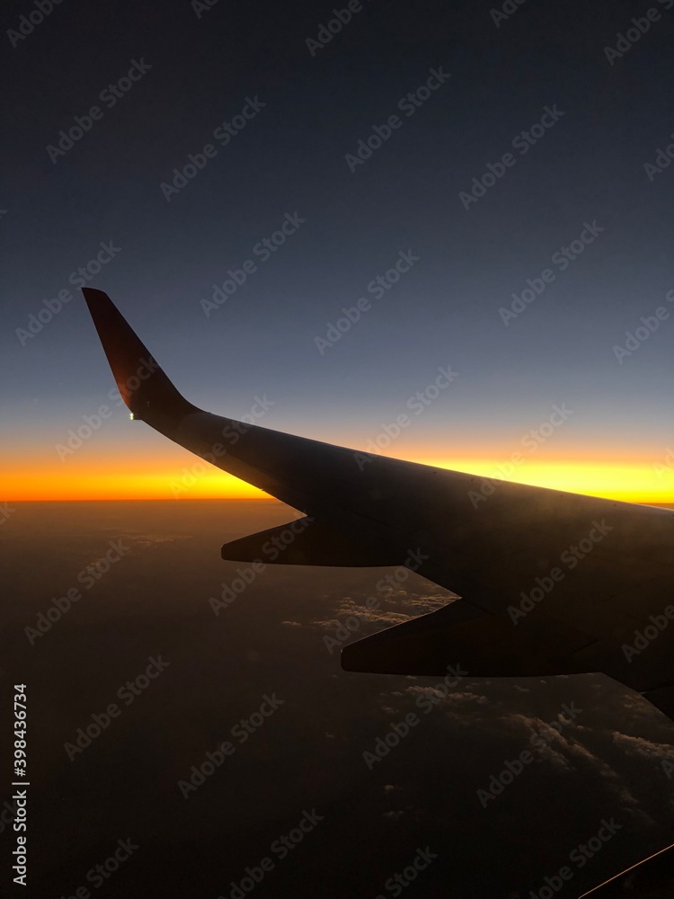 Sunset from airplane window view.