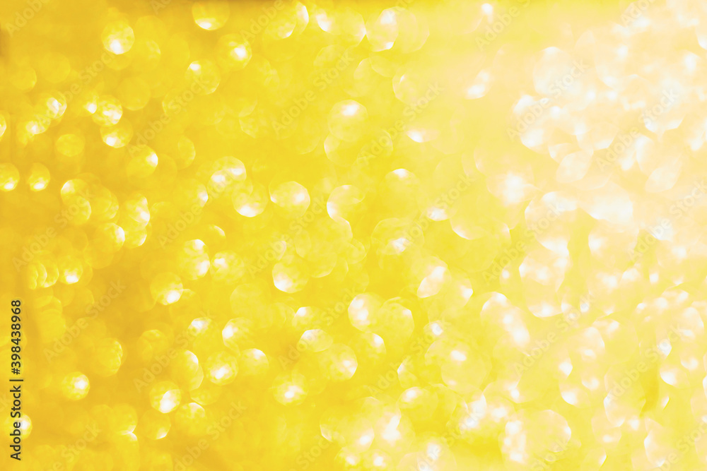 Abstract blurred yellow sparkle bakground.