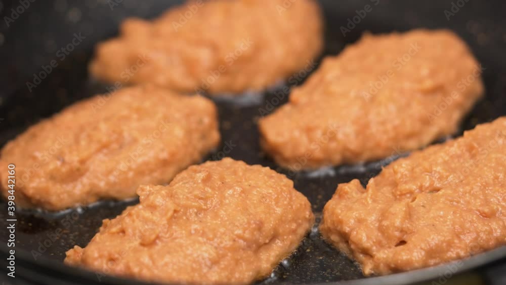 Close up fried juicy fish cutlets in frying pan.