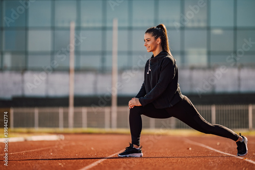Athlete girl doing exercises in the morning. © bnenin
