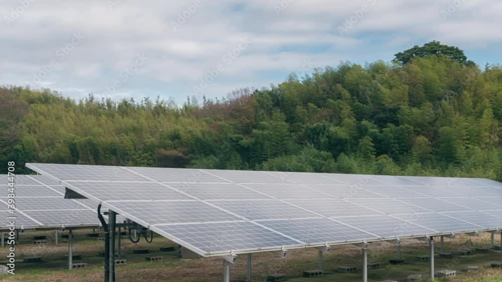 4K Time-lapse large industrial Solar Energy Farm producing concentrated solar power generating clean electricity against mountain and cloud background, green energy concept. 4K Time-lapse large industrial Solar Energy Farm producing concentrated solar power generating clean electricity against mountain and cloud background, green energy concept.