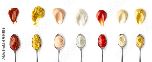 Set of different sauces in spoons top view isolated on white background