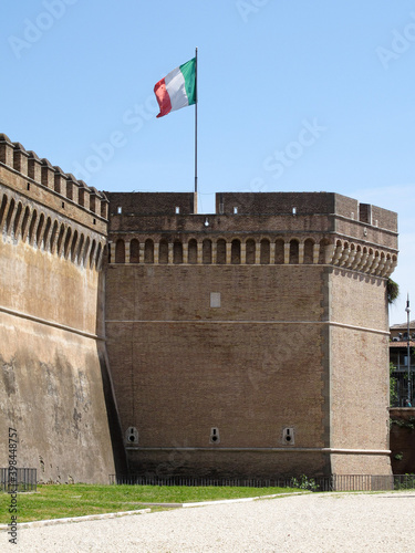 A flag flying atop Castel Sant’Angelo, also known as Hadrian’s Mausoleum. It was built between between 123 – 139 AD. Image has copy space.