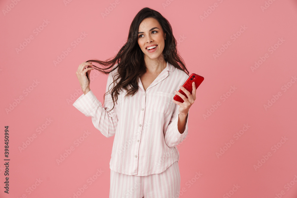 Cheerful beautiful woman smiling while using mobile phone Cheerful beautiful woman smiling while using mobile phone
