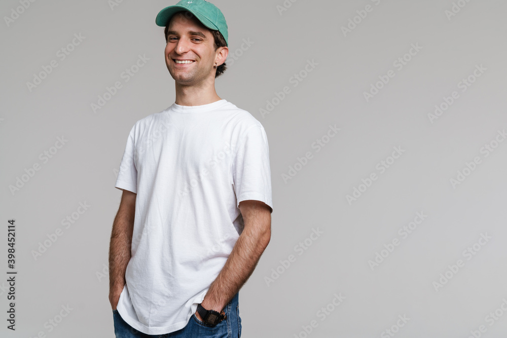 Young happy man in cap smiling and looking at camera Young happy man in cap smiling and looking at camera