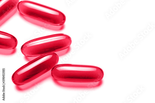 Pink capsules isolated on white. Red pills medicine background. Drugs dose in group. Painkiller pills pile. Pharmacy virus cure. Empty copy space tablets backdrop. Healthcare studio backdrop.