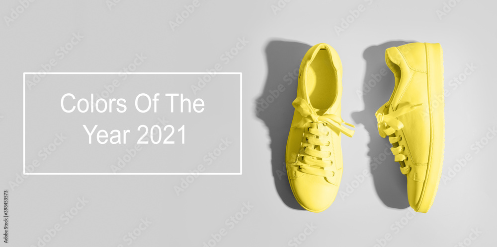 Banner with yellow female gumshoes on grey background. View from above. Space for text. Trendy color Ultimate Grey and Illuminating of the 2021 year. Space for text. Banner with yellow female gumshoes on grey background. View from above. Space for text. Trendy color Ultimate Grey and Illuminating of the 2021 year. Space for text.